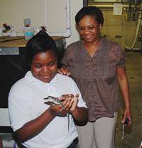 student with baby gator