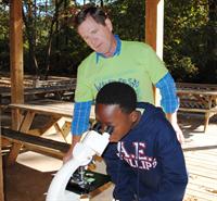 student at microscope